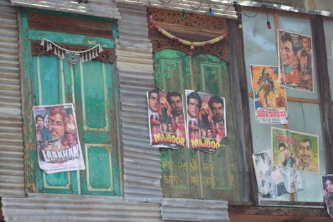 Green doors covered with vintage Bollywood posters