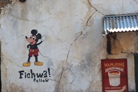 Mickey Mouse mural on a weathered wall